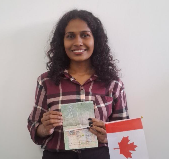 Tharudi holding her Canadian study permit and a Canadian flag